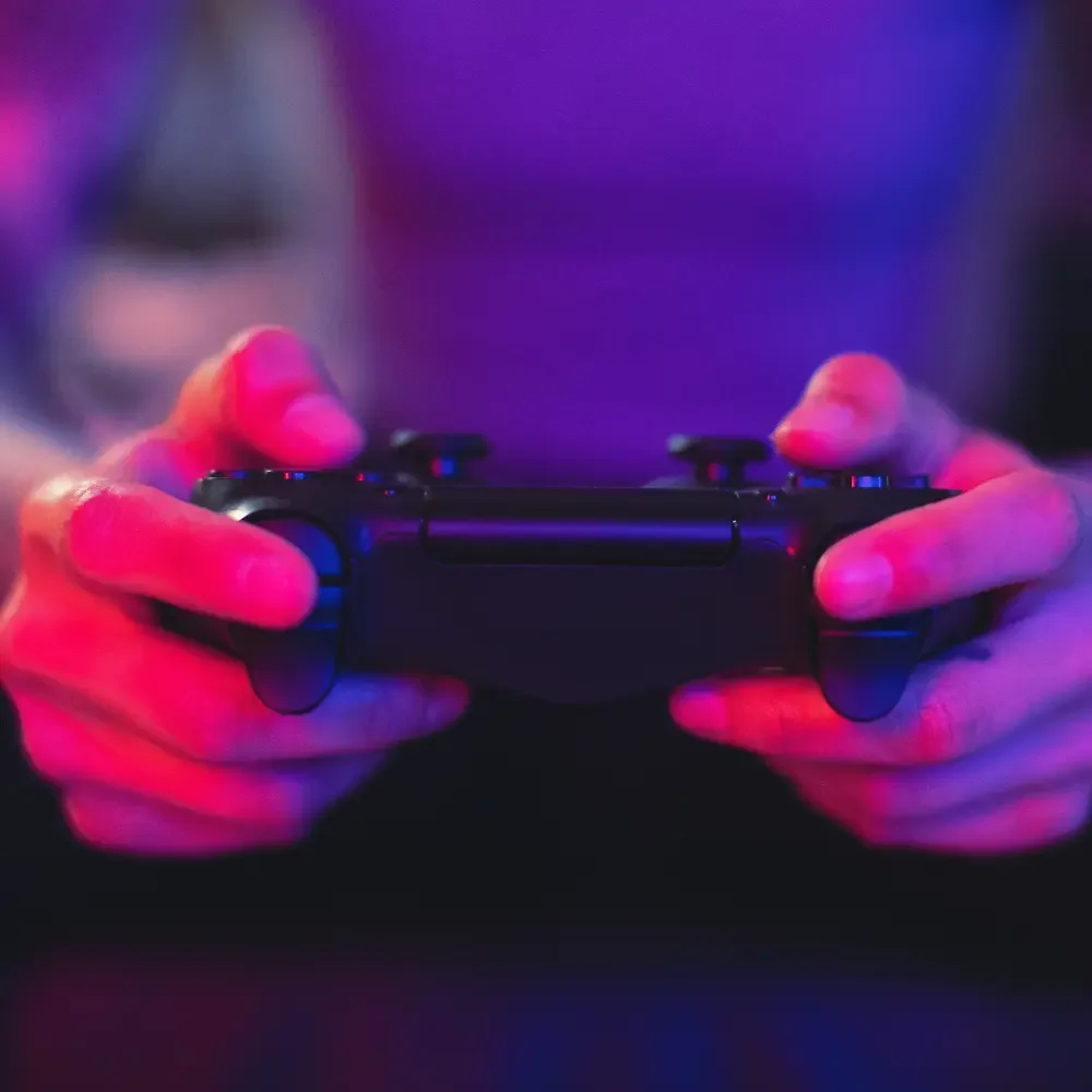 bsl-ab-f2-1 Close-up of english to japanese translator holding controller, testing immersive localized game experience