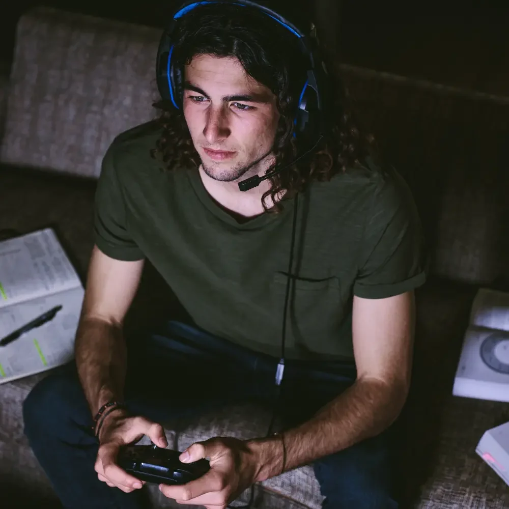 bsl-hp-f2-4 man wearing headphones and testing japanese to english localization of video game